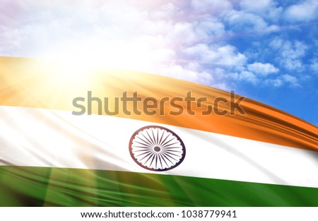 flag of India against the blue sky with sun rays