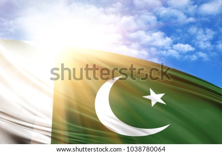 flag of Pakistan against the blue sky with sun rays