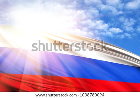flag of Russia against the blue sky with sun rays