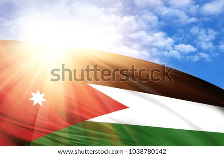 flag of Jordan against the blue sky with sun rays