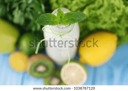 healthy food concept. milkshake in glass and fresh green vegetables. picture with soft focus
