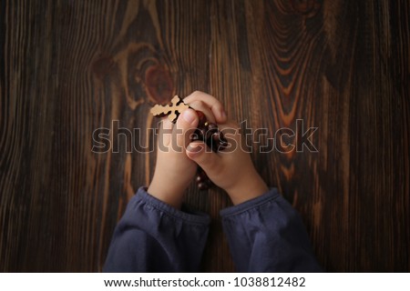 Religious Christian girl praying at table, closeup
