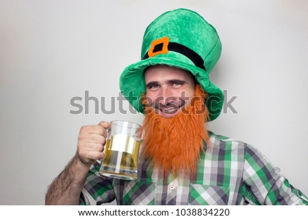 Saint Patrick's Day concept. Smiling man in Leprechaun hat and red beard on light background. 