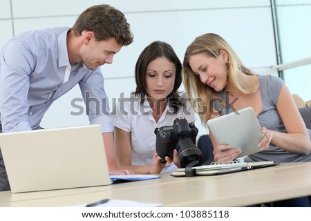 Team of photo reporters working in office