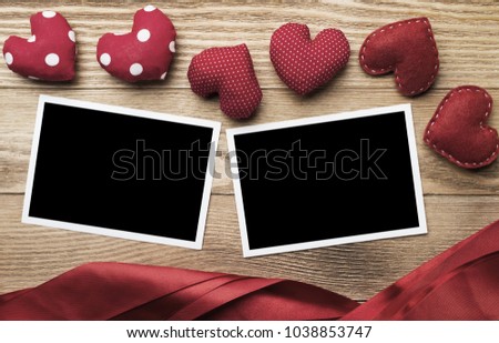 Blank instant photo and love hearts on wooden table background