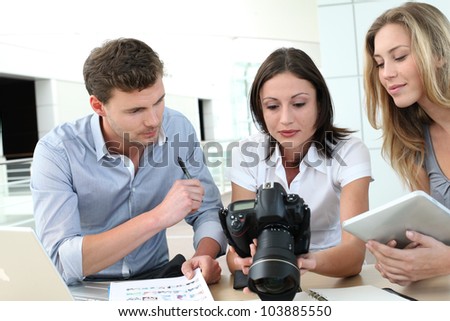 Team of photo reporters working in office