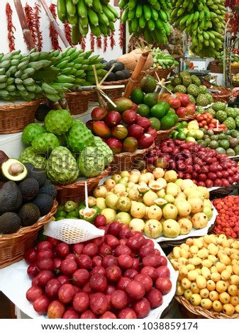 Fruit market with various colorful fresh fruits and vegetables.