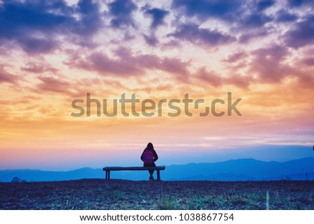 Mountains view point valley during sunrise and silhouette woman sitting and looking landscape from Phulomlo Thailand