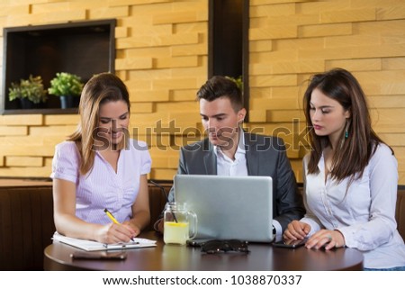 Coworkers having meeting  in the cafe