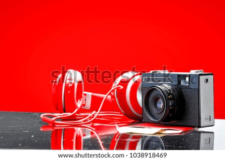 Summer camera on desk with free space for your decoration and red background 