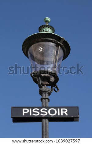 Street light with pissoir sign in Copenhagen, Denmark