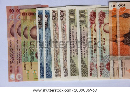 Vietnamese money dong (VND) on white background. Just printed new bills. Chaotic mix of different money nominations. Asian currency background for business, finance and economical issues. Money photo
