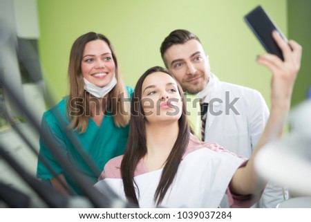 Medical dentist team taking a selfie with patient
