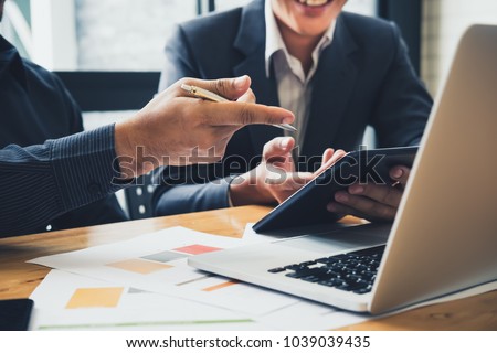 Asian business adviser meeting to analyze and discuss the situation on the financial report in the meeting room.Investment Consultant,Financial Consultant,Financial advisor and accounting concept Royalty-Free Stock Photo #1039039435