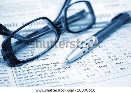 pen and glasses on the financial table
