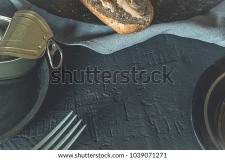 Tuna sandwich with whole wheat bread, healthy food, black food, on a rustic background.