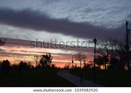 Colorful sky with horizontal shape clouds late in the evening during winter season, Kern County, CA.