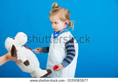 Boy play vet doctor with toy sheep in mothers hand. Child veterinarian examine toy animal with stethoscope. Veterinary clinic game. Future profession concept. Health, healthcare, medicine, copy space