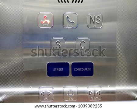 A modern day lift with stainless steal interiors seen with big buttons for aged people and Braille dots for blind people