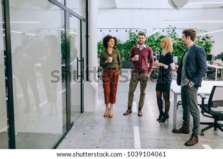 Group of coworkers having a coffee break Royalty-Free Stock Photo #1039104061