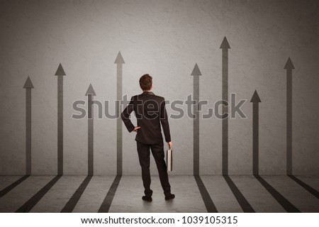 Sales person in doubt looking at arrows pointing up on the wall concept
