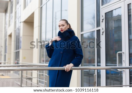 Beautiful elegance lady woman, has blue fur coat, walking in city street. Urban city portrait. People lifestyle. Woman fashion style. Autumn stylish. 