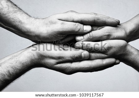Concept of caring, tenderness, protection. Male and female hands touch each other. Royalty-Free Stock Photo #1039117567