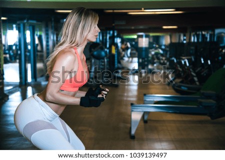 beautiful blonde woman in the gym training 
