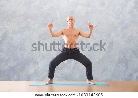 man praticing tai chi chuan in the gym. Chinese management skill Qi's energy. WU-SHU. Man practice yoga 