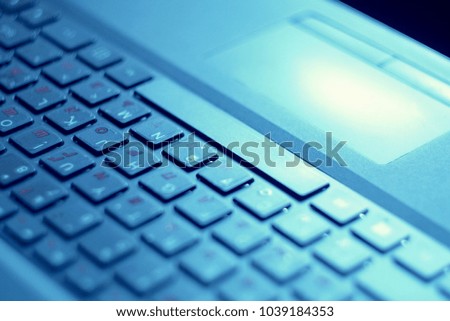  keyboard on a laptop in a blue color close-up                               