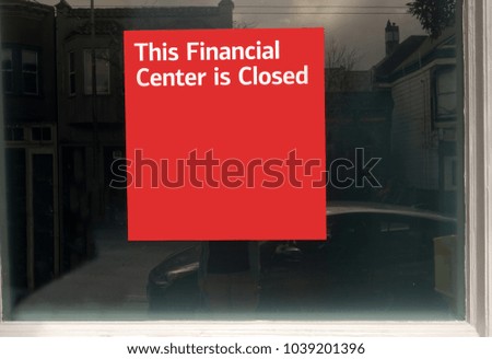 THIS FINANCIAL CENTER IS CLOSED notice posted inside on window of former bank.