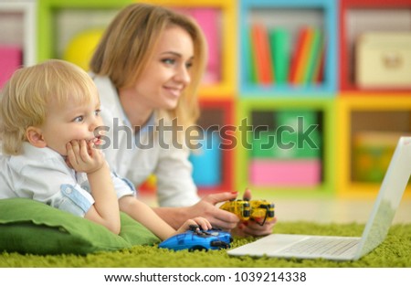 Mother and son using laptop 