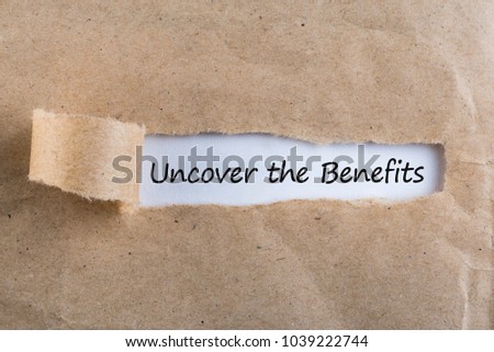Uncover The Benefits text on brown envelope. Word Uncover The Benefits on torn paper. Concept Image. Royalty-Free Stock Photo #1039222744