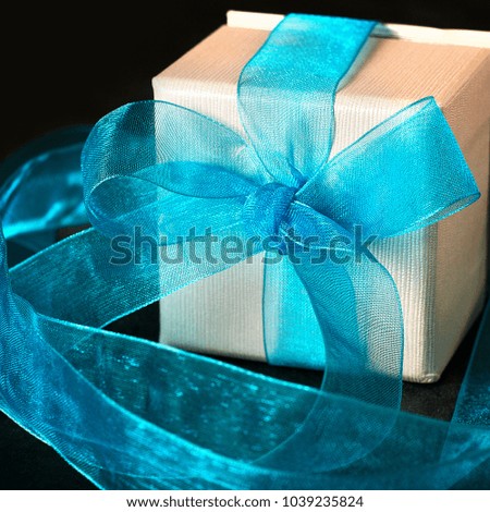 flowers and gift on black background