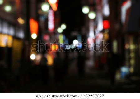 Bokeh Effect of the walkway street in night city with people, as background abstract wallpaper.