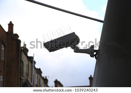 Security cameras around a train station in London England on a bright day.