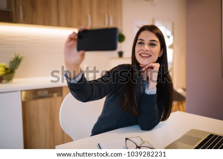 Beautiful brunette girl taking selfie.