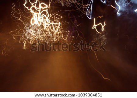 Abstract pattern of dancing, chaotic light trails at night.