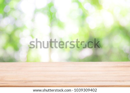 Empty wooden table with Defocus nature green bokeh, abstract nature background with green leaves and bokeh lights.