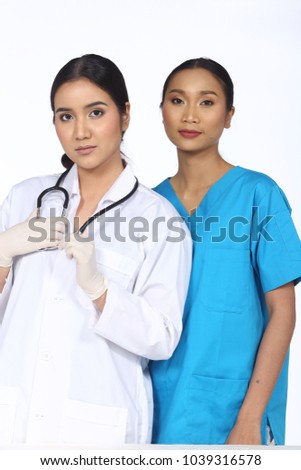 Asian Beautiful Doctor Nurse woman in white blue uniform with stethoscope and rubber gloves, portrait half body make up black hair, studio lighting copy space for text logo