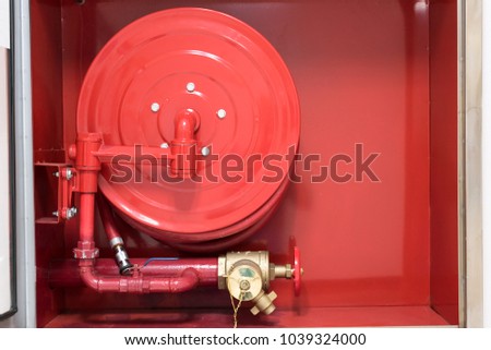 Fire hose equipment in a red metallic box.Rescue firefighter and fire line in red box.Fire fighting concept.