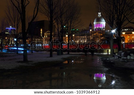 Old Montreal street view with historical buildings. Old Port of Montreal by night. View of old port in Montreal. Montreal Downtown Panorama at winter night.