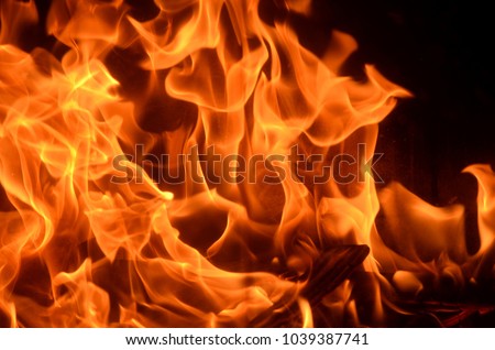 Burning fire with red, orange and yellow flames background. Arson, house fire, fire safety and fire danger theme. Royalty-Free Stock Photo #1039387741