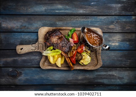 Ribeye steak on bone served with sauce Jack Daniels