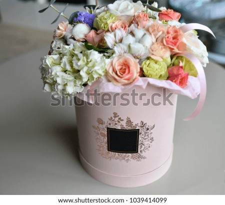 Delicate bouquet in a pink round box with label for signature
