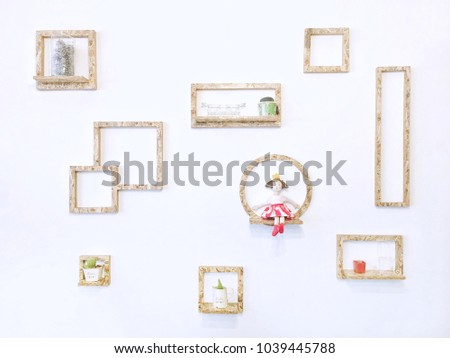 Crop white wall. Set of Different shapes of Wooden frames on white wall in soft tone colour picture. Interior design home. Decorated concept.