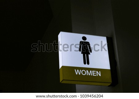 The sign of the female toilet on night.