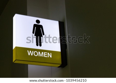 The sign of the female toilet on night.