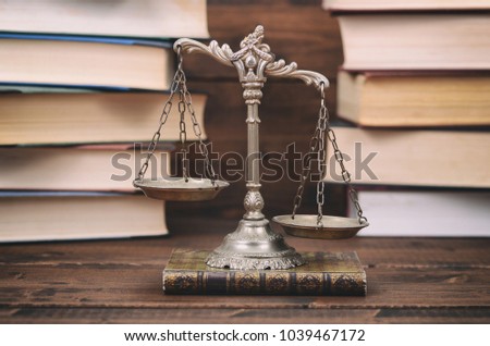 Law and Justice, Legality concept, Scales of Justice and law books on a wooden background.