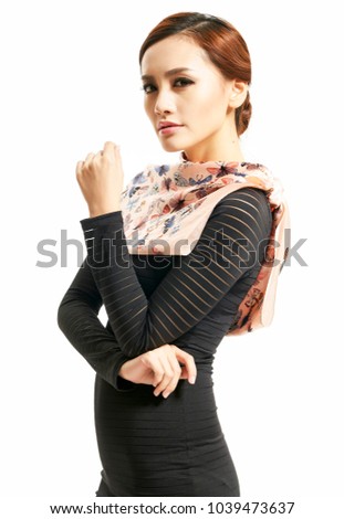 Beautiful oriental girl wearing silk scarf over white background